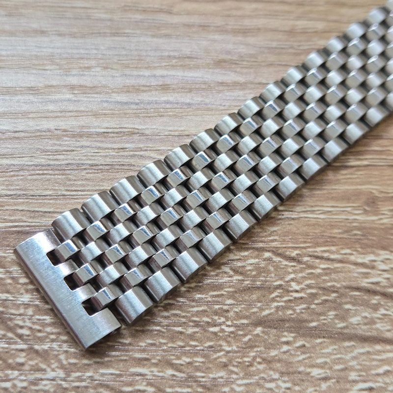 Stainless steel watch bracelet showing polished and brushed surfaces