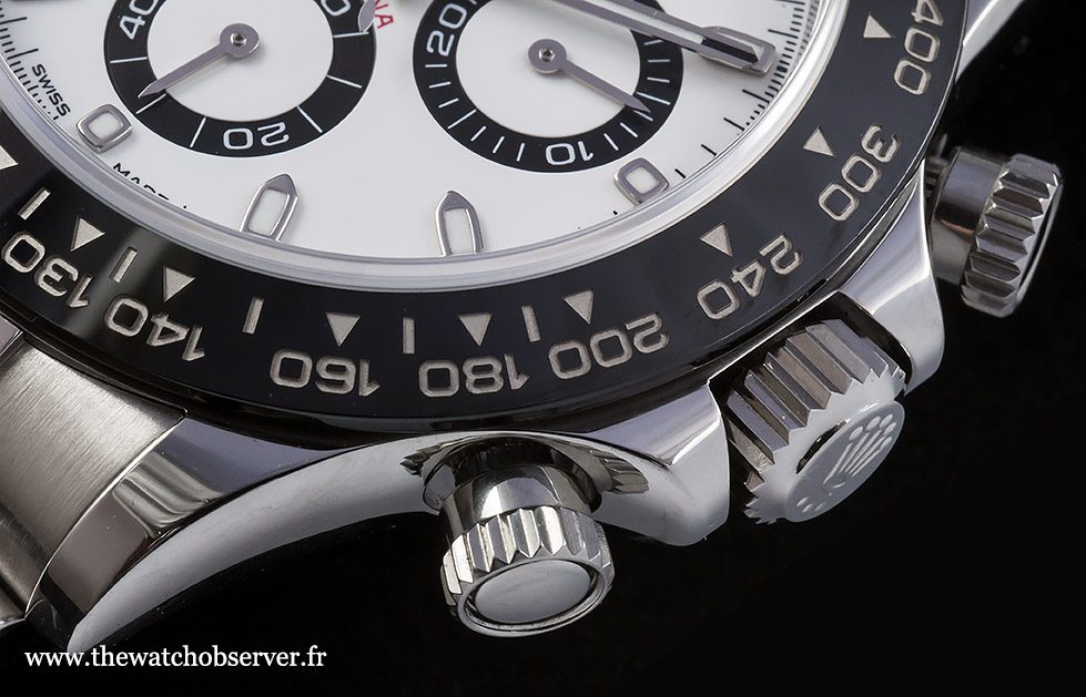 Rolex Daytona chronograph pushers and crown close-up showing screw-down mechanism and tachymeter bezel