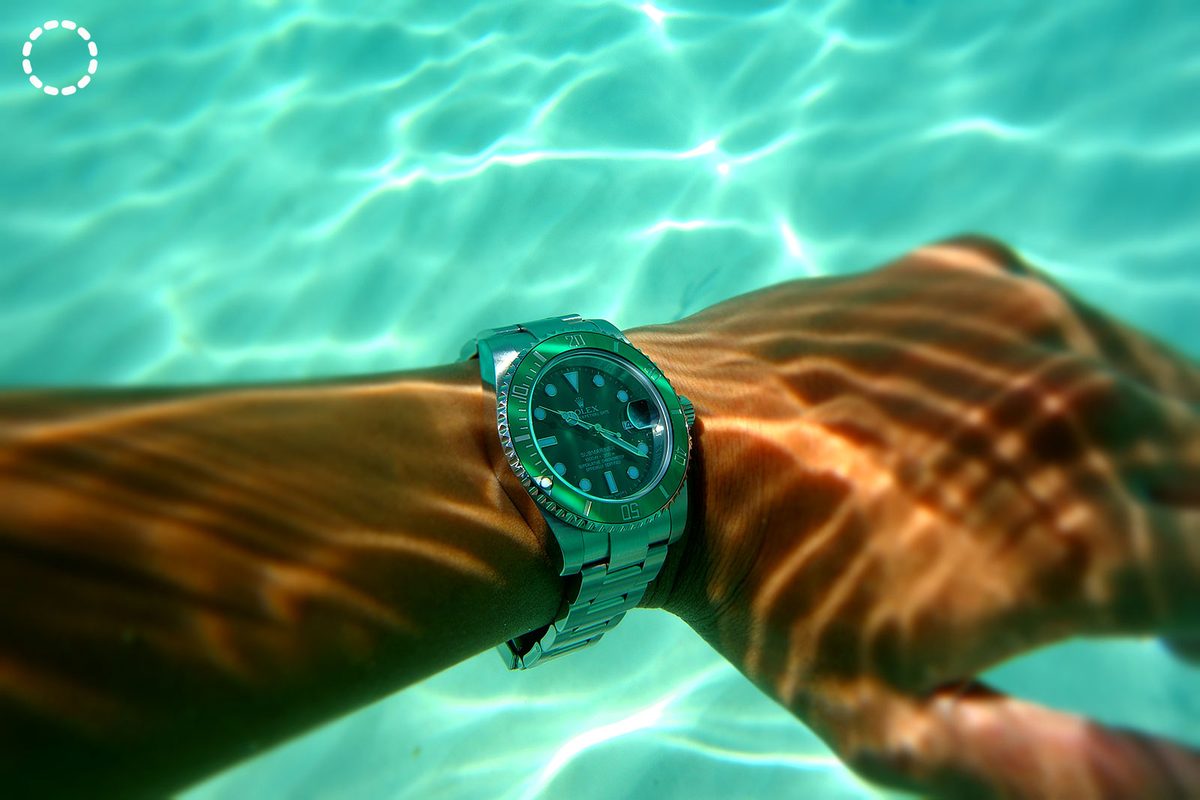 Rolex Submariner on wrist during dive in ocean water showing the watch in its element
